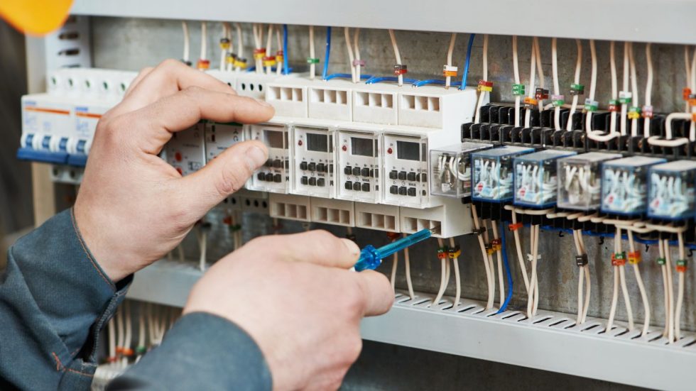 Electrician Working On Circuit Panel